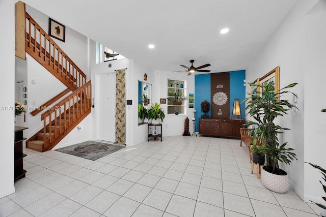 tiled foyer with ceiling fan