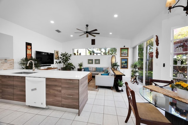 kitchen featuring a wealth of natural light, sink, ceiling fan, and vaulted ceiling