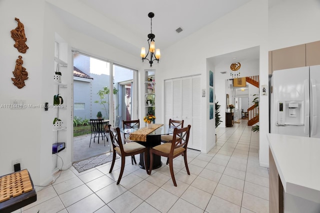 dining space with light tile patterned flooring, vaulted ceiling, and a notable chandelier