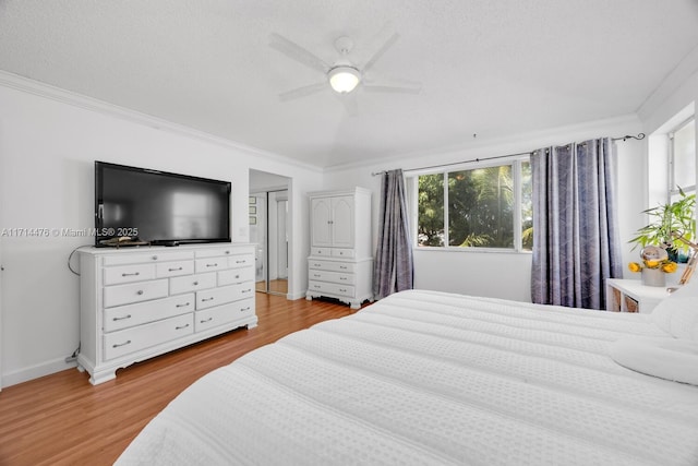 bedroom with ceiling fan, crown molding, and light hardwood / wood-style flooring