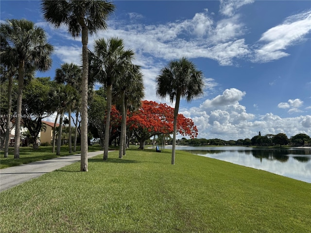 view of community featuring a yard and a water view