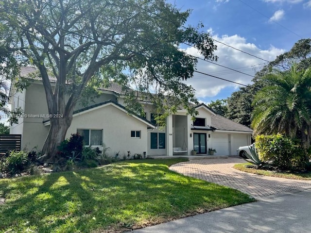 view of front facade featuring a front yard and a garage