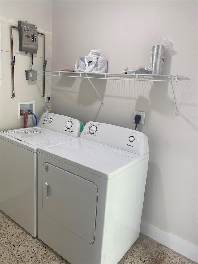 clothes washing area featuring separate washer and dryer