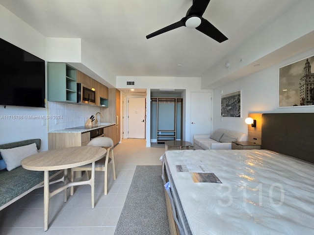 bedroom featuring ceiling fan and light tile patterned floors