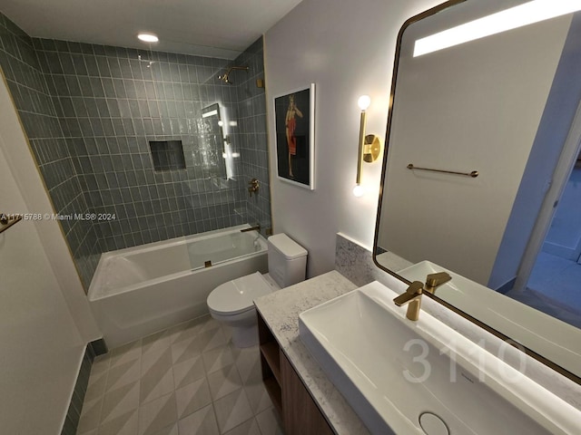 full bathroom featuring tile patterned flooring, tiled shower / bath combo, toilet, and vanity