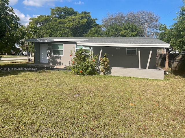 rear view of house with a lawn