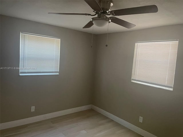 unfurnished room with light wood-type flooring and ceiling fan