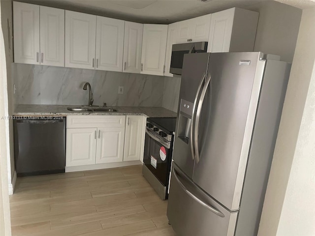 kitchen with white cabinetry, sink, and appliances with stainless steel finishes