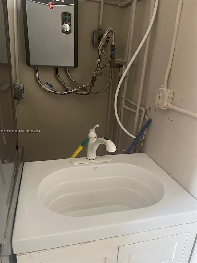 bathroom with water heater and sink