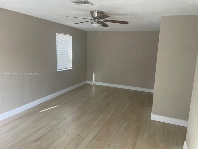 empty room featuring light wood-type flooring and ceiling fan