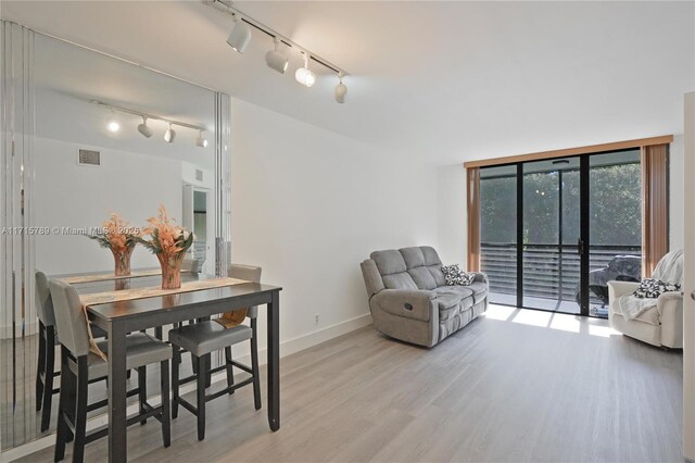 living room with hardwood / wood-style floors and a wall of windows