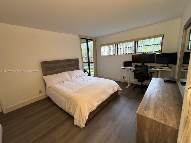 bedroom with dark hardwood / wood-style flooring and multiple windows