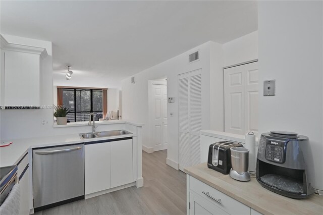 kitchen with white cabinets, dark hardwood / wood-style floors, sink, and appliances with stainless steel finishes