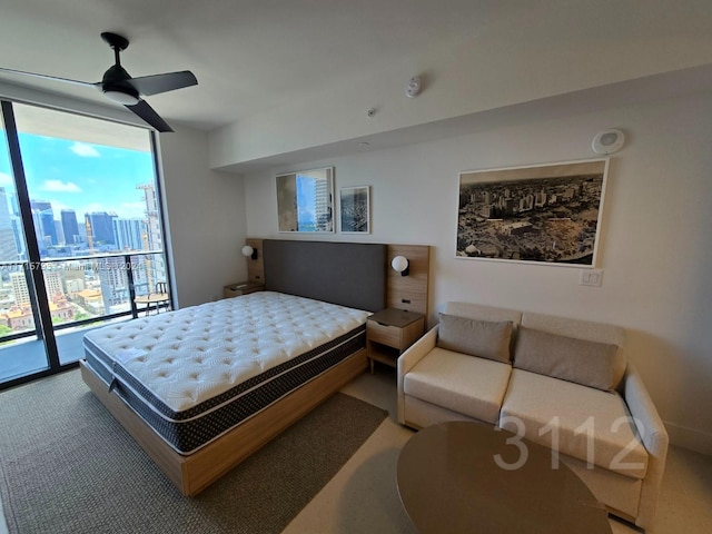 bedroom with access to outside, floor to ceiling windows, ceiling fan, and carpet floors