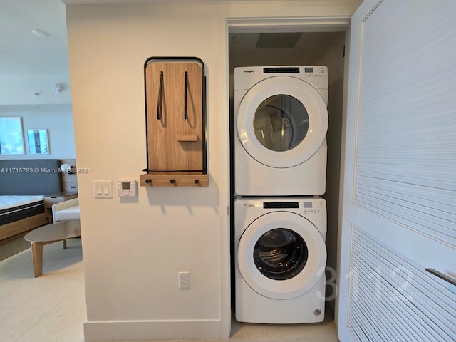 laundry room with stacked washing maching and dryer