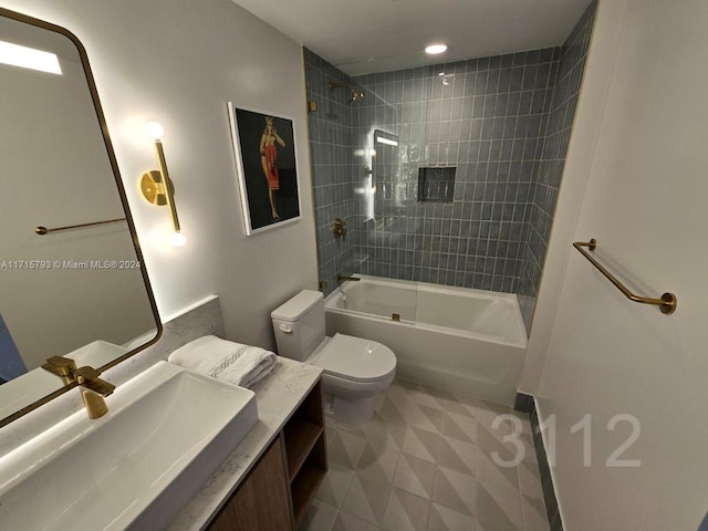 full bathroom featuring tiled shower / bath combo, toilet, and vanity