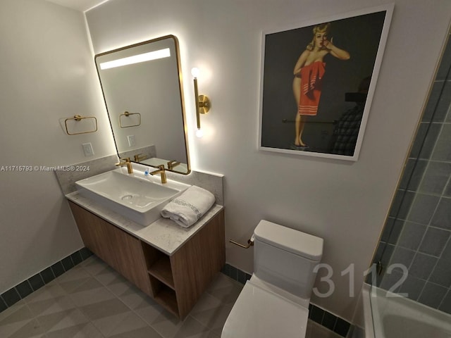 bathroom featuring tile patterned flooring, vanity, and toilet