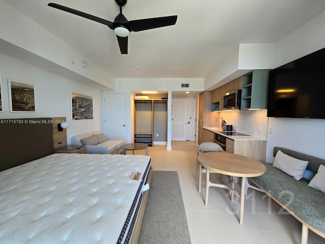 bedroom with a closet, a spacious closet, and ceiling fan