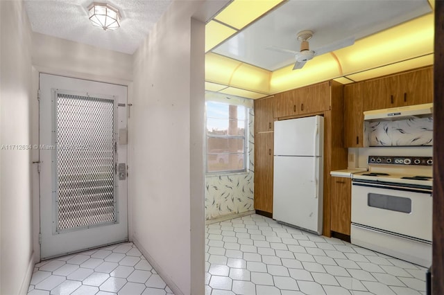 kitchen with ceiling fan, white appliances, and a textured ceiling