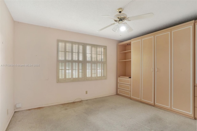 unfurnished bedroom with ceiling fan and light carpet