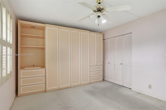 unfurnished bedroom with multiple windows, light colored carpet, a closet, and ceiling fan