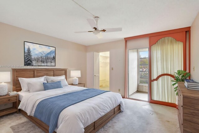 bedroom featuring ceiling fan, light carpet, and connected bathroom