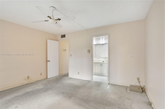 unfurnished room with ceiling fan and light colored carpet