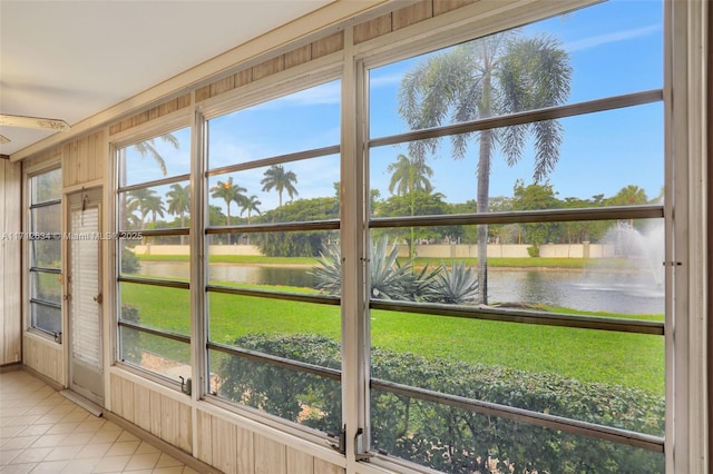 unfurnished sunroom with a water view and a wealth of natural light