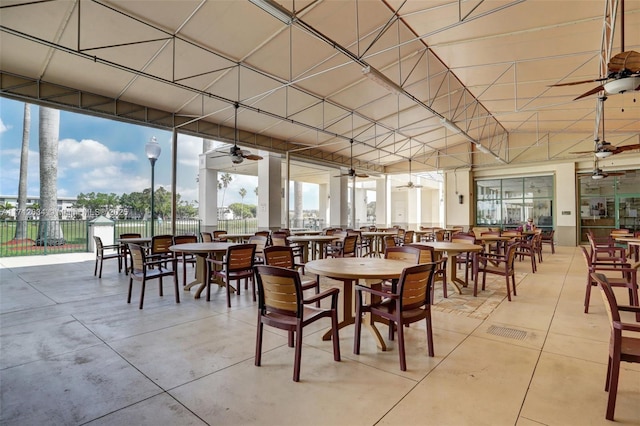 dining room with floor to ceiling windows and ceiling fan