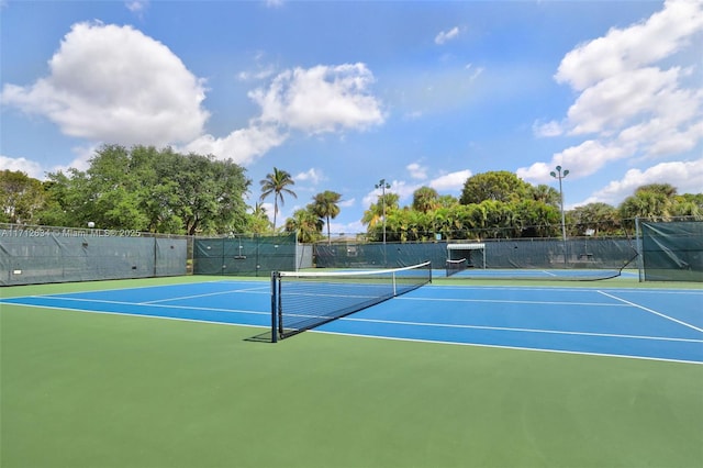 view of tennis court featuring basketball court