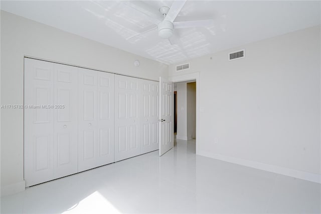 unfurnished bedroom featuring light tile patterned floors, a closet, and ceiling fan