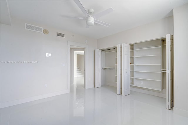 unfurnished bedroom featuring ceiling fan and light tile patterned floors