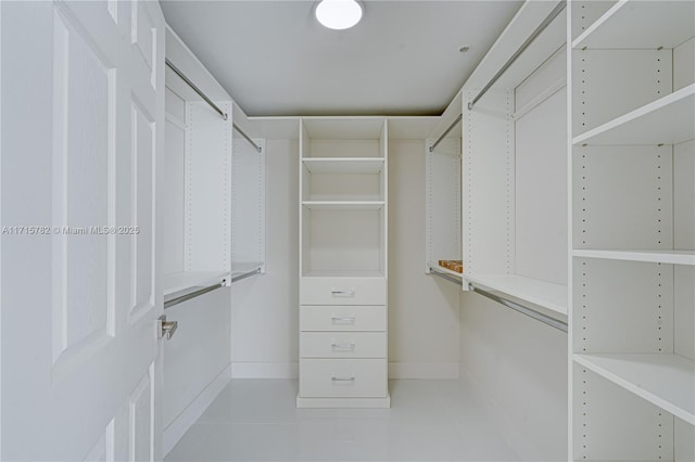 spacious closet with light tile patterned floors