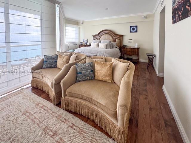 bedroom with dark hardwood / wood-style floors, ornamental molding, and access to outside