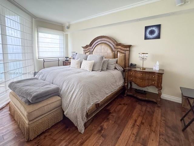 bedroom featuring dark hardwood / wood-style floors and ornamental molding