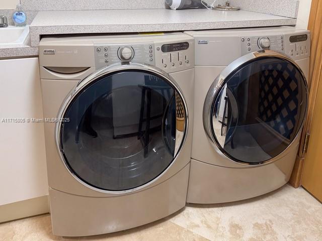 clothes washing area featuring independent washer and dryer