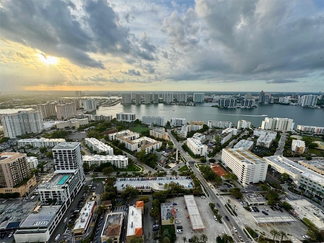 aerial view at dusk featuring a water view