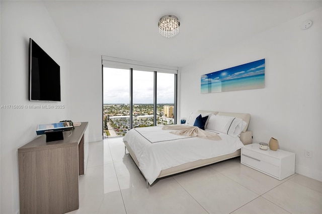 bedroom with expansive windows and light tile patterned floors