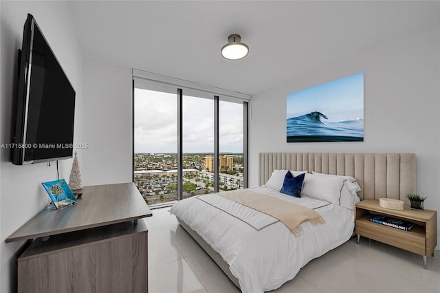 bedroom with expansive windows and light tile patterned flooring