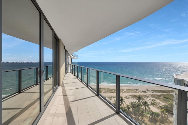 balcony featuring a water view and a view of the beach