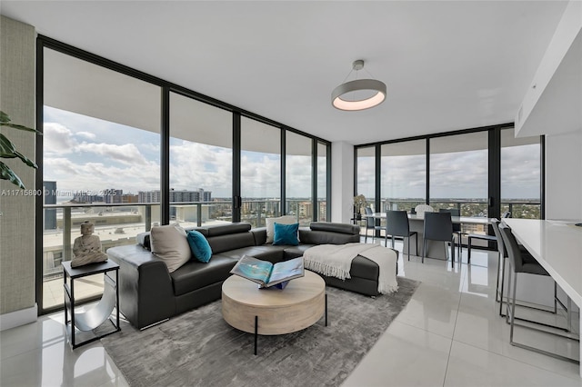 living room with floor to ceiling windows and light tile patterned floors