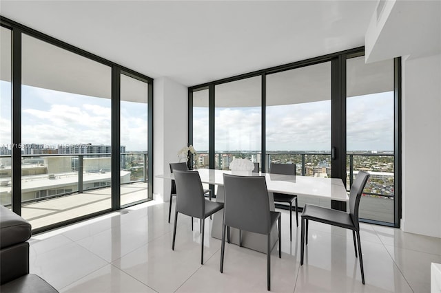 dining space featuring expansive windows and light tile patterned flooring