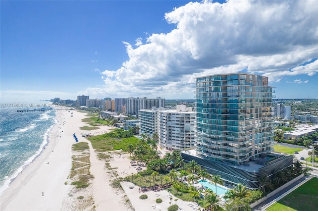 drone / aerial view with a beach view and a water view