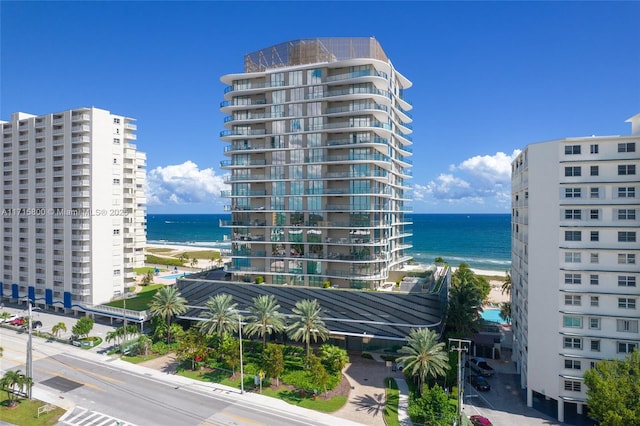 view of property featuring a water view and a beach view