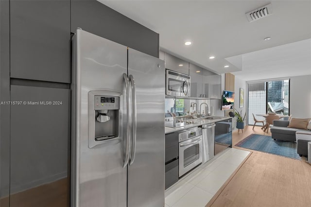 kitchen featuring sink, light wood-type flooring, and appliances with stainless steel finishes