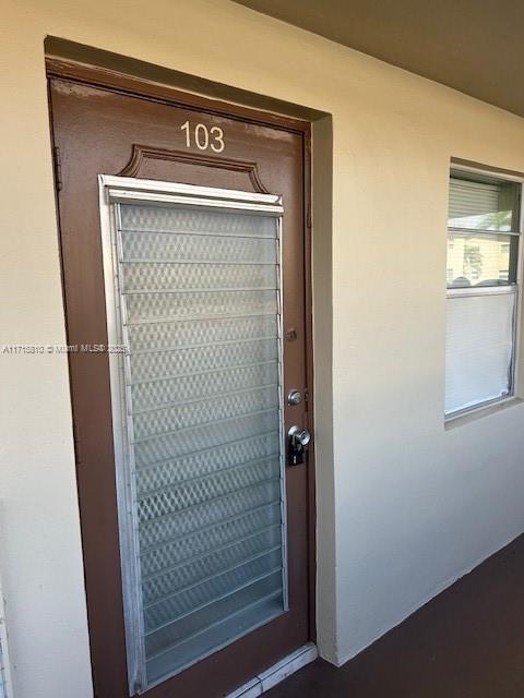 7500 NW 5th Pl Unit 103, Margate, FL 33063 - doorway to property with stucco siding