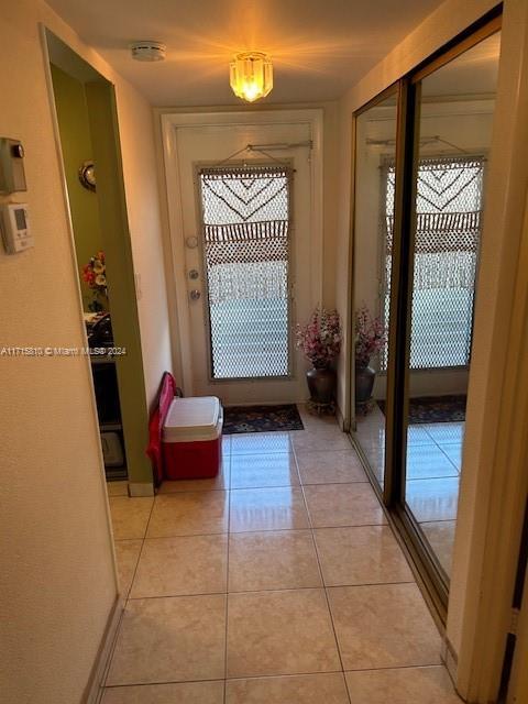 entryway with light tile patterned floors