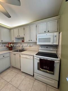 7500 NW 5th Pl Unit 103, Margate, FL 33063 - kitchen with white appliances, light tile patterned flooring, light countertops, and ceiling fan