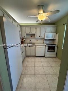 7500 NW 5th Pl Unit 103, Margate, FL 33063 - kitchen with white appliances, light tile patterned flooring, light countertops, and a ceiling fan