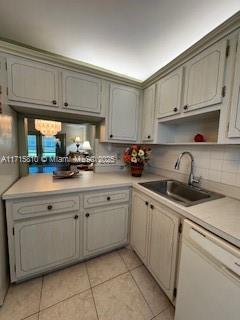7500 NW 5th Pl Unit 103, Margate, FL 33063 - kitchen featuring dishwasher, light tile patterned flooring, light countertops, and decorative backsplash